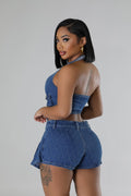Side angle shot of a woman wearing her Two-Piece Denim Skort with Halter Top