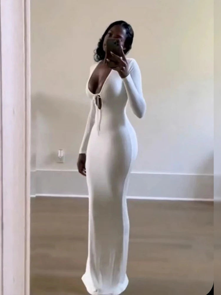 Close-up mirror shot of a woman wearing white Ribbed Long Sleeve Maxi Dress with Lace Up V-Neckline