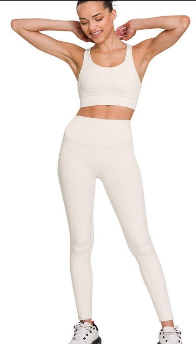 Side angle shot of a woman wearing a white emery athletic legging set.