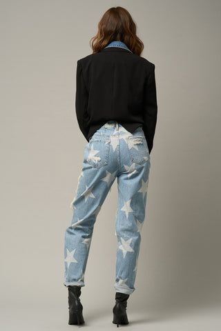 Sample of a woman wearing her High-Waisted Star Print Ripped Jeans in back aspect.