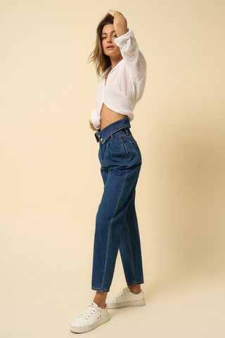 Side details of a woman wearing her High-Rise Flap Waist Relaxed Jeans