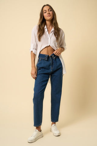 Full image of a woman wearing her High-Rise Flap Waist Relaxed Jeans
