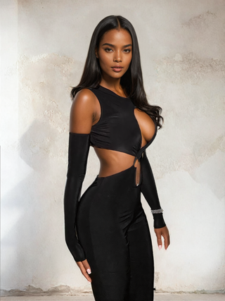 Side Angle Shot of a woman wearing the black Cut-Out Cross Chest Jumpsuit