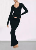 Woman wearing the Kim Kardashian's Black High-Waisted Mid-Length Skirt with Hip Wrap