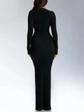 Back Angle of a woman wearing the black Ribbed Long Sleeve Maxi Dress with Lace Up V-Neckline