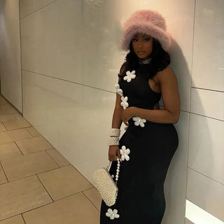 Side Angle of a Woman wearing Black High Neck Maxi Dress with White Patch Flowers
