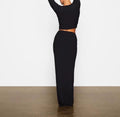 Back Angle of a Woman wearing the Kim Kardashian's Black High-Waisted Mid-Length Skirt with Hip Wrap