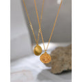 Close-up photo of two Round Moon and Sun Pendant Necklace