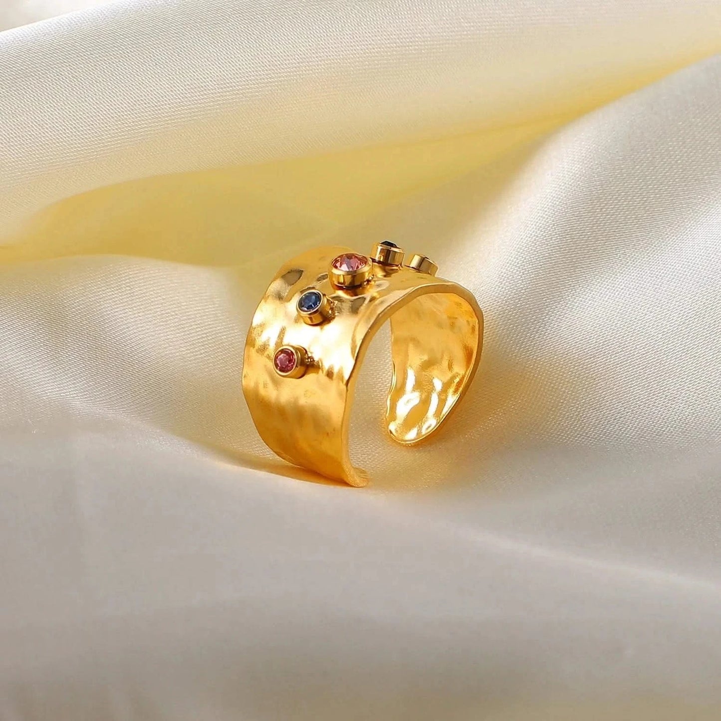 Close-up photo of a gold Ring with a Colorful Cubic Zirconia Crystals