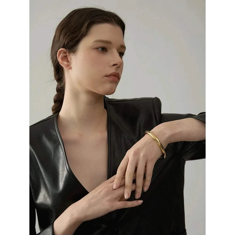 Woman wearing her gold  Plain Bangles