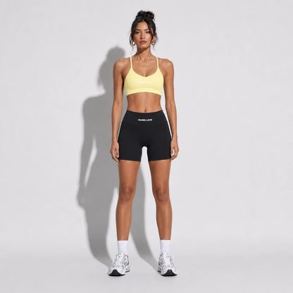 Set — Infinity bra yellow + Legging Shorts black front on-model 2048